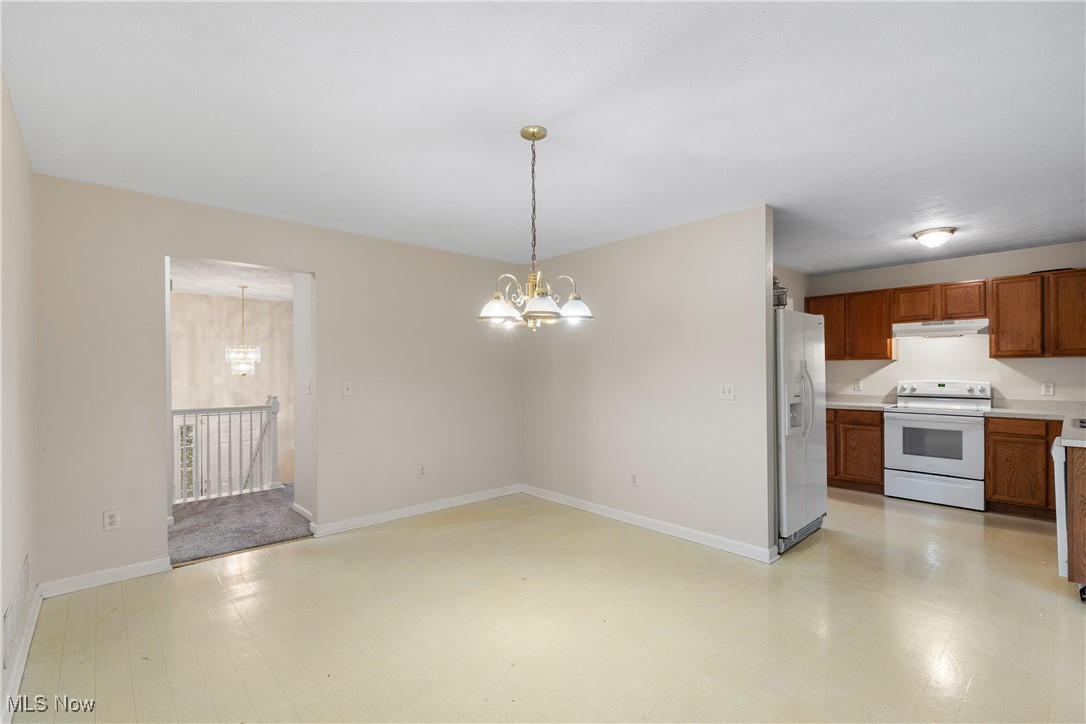 1333 Derbydale Road Akron, OH 44306 - Photo 12 of 29 Dining area with light flooring and a chandelier