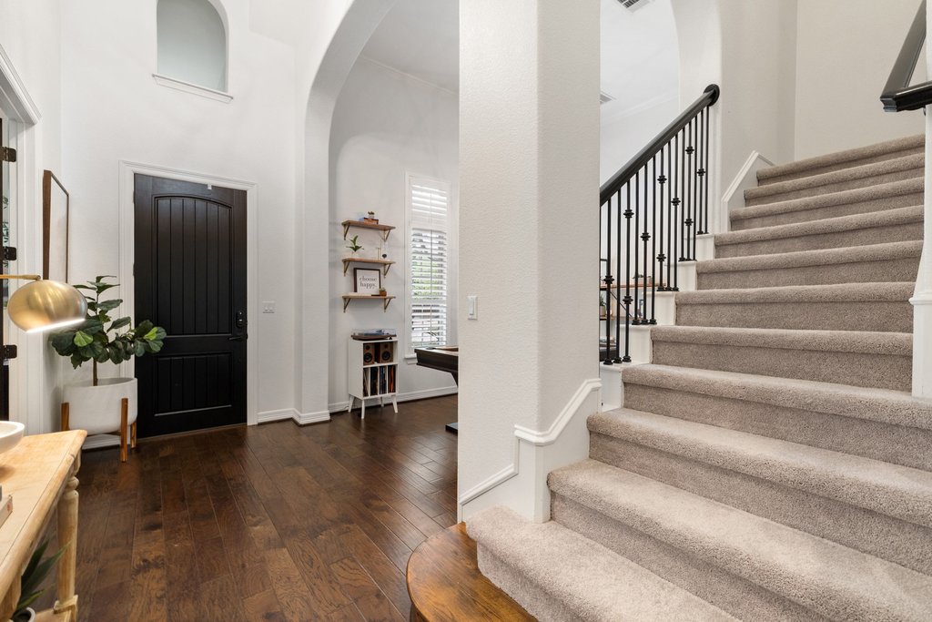 8801 Wild Rice Cove Austin, TX 78738 - Photo 26 of 40 a view of staircase with wooden floor and a potted plant