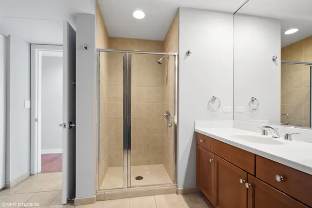 a bathroom with a shower sink and mirror