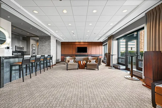 a view of a livingroom with furniture and staircase