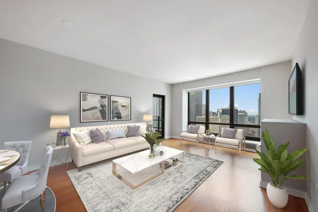 a living room with furniture and a potted plant