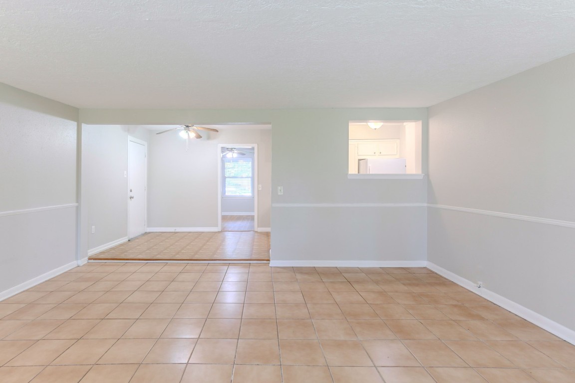 6609 Imogene Street Houston, TX 77074 - Photo 19 of 33 a view of an empty room with window and chandelier fan