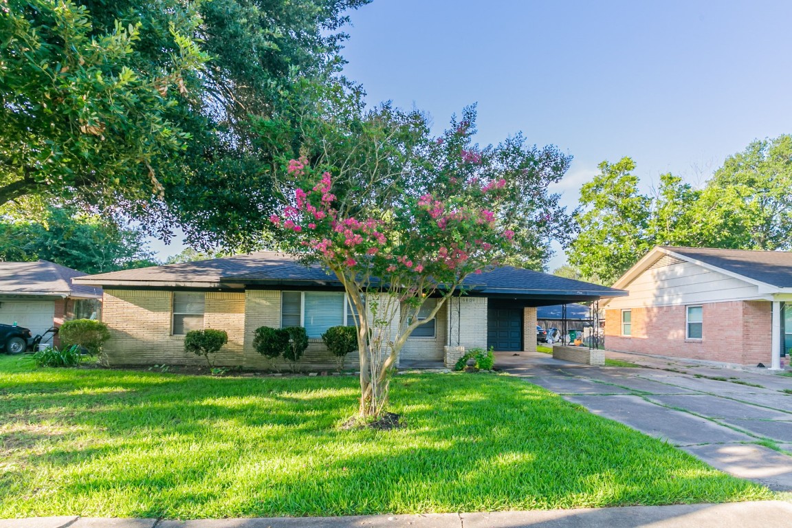 6609 Imogene Street Houston, TX 77074 - Photo 2 of 33 a front view of a house with a yard and green space