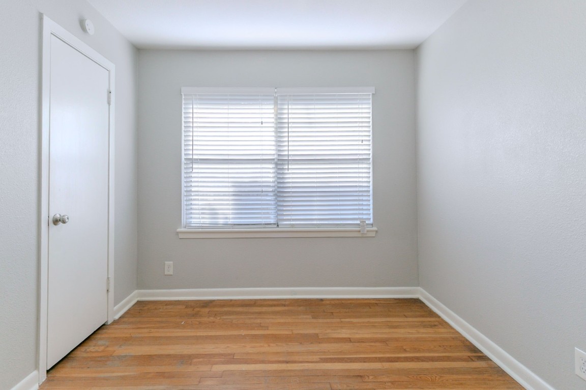 6609 Imogene Street Houston, TX 77074 - Photo 23 of 33 a view of an empty room with wooden floor and a window