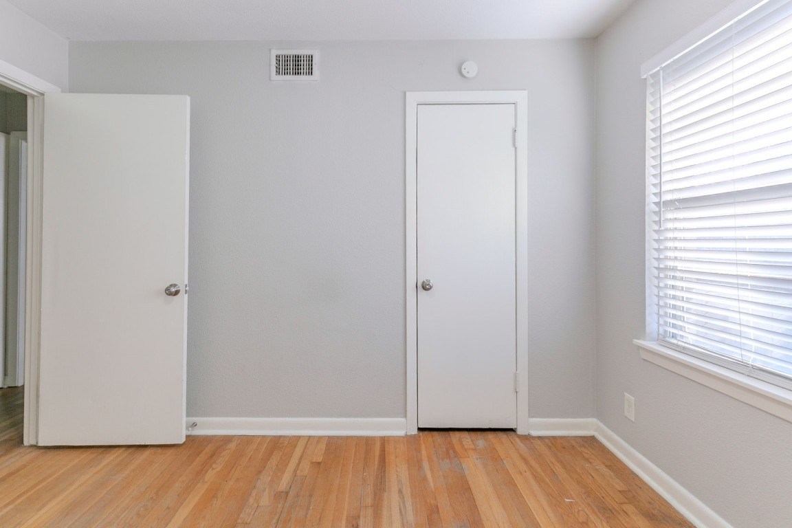 6609 Imogene Street Houston, TX 77074 - Photo 24 of 33 an empty room with wooden floor and windows