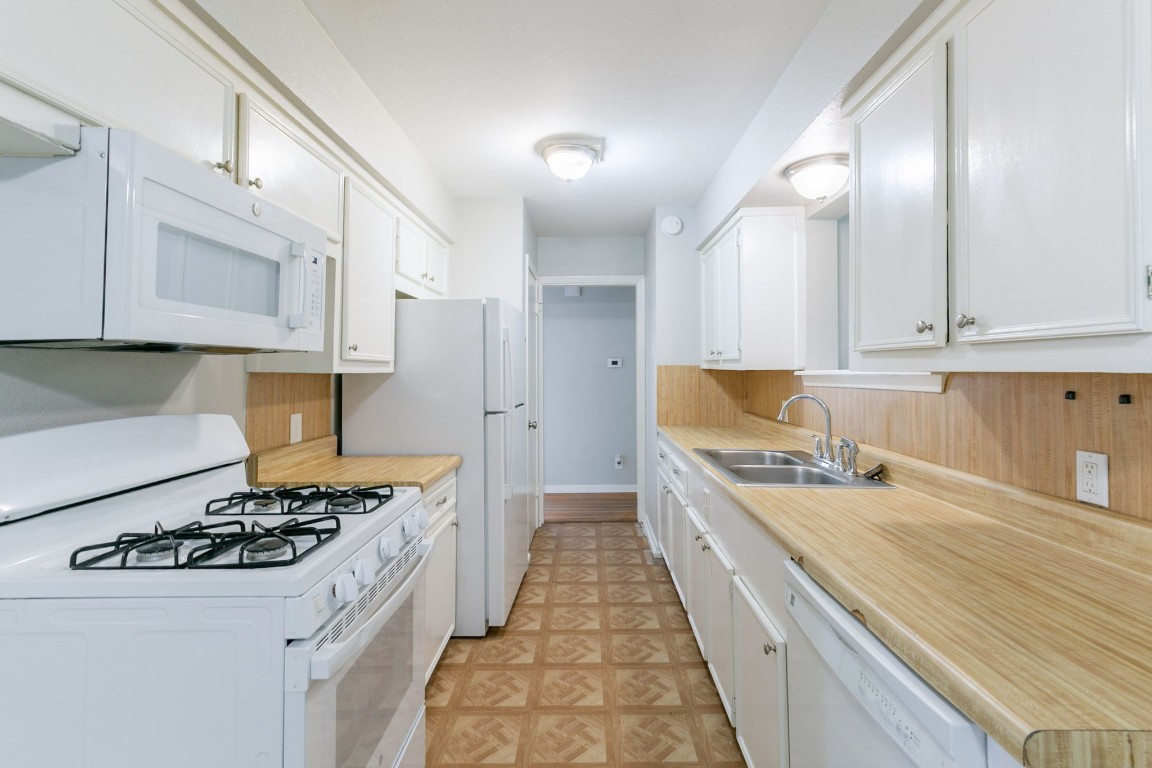 6609 Imogene Street Houston, TX 77074 - Photo 8 of 33 a kitchen with a stove a sink and a refrigerator