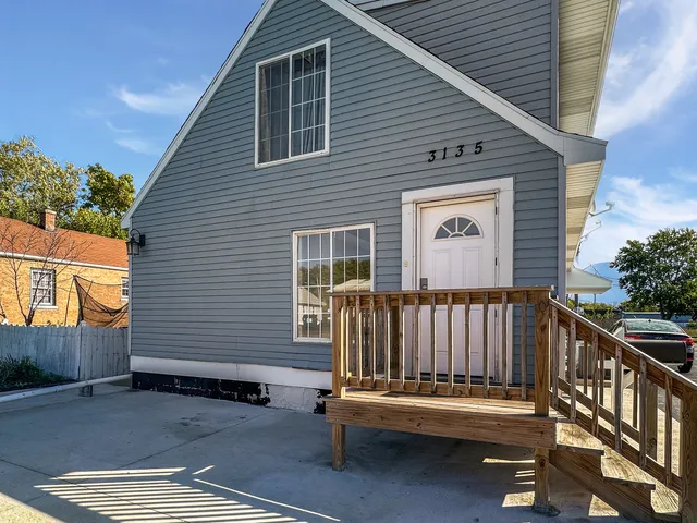 a view of backyard with deck and outdoor seating