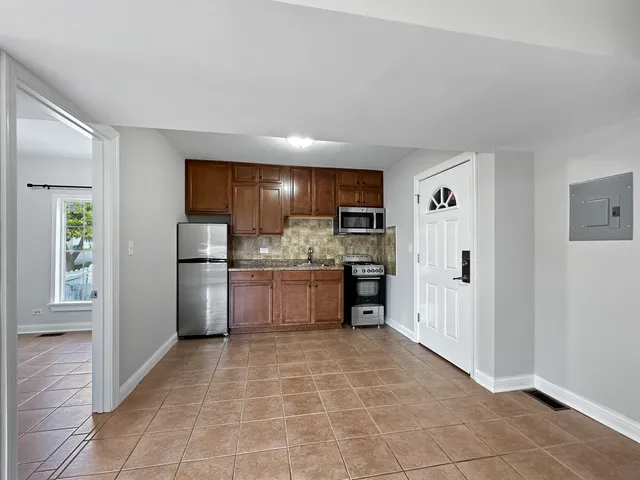 a kitchen with a refrigerator and cabinets