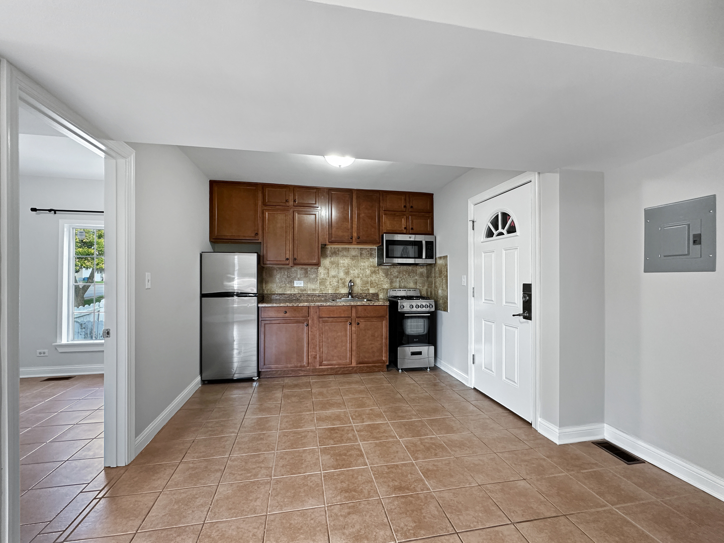 3135 Chicago Road, Unit 1FRONT Steger, IL 60475 - Photo 6 of 13 a kitchen with a refrigerator and cabinets