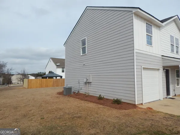 a view of a house with a backyard