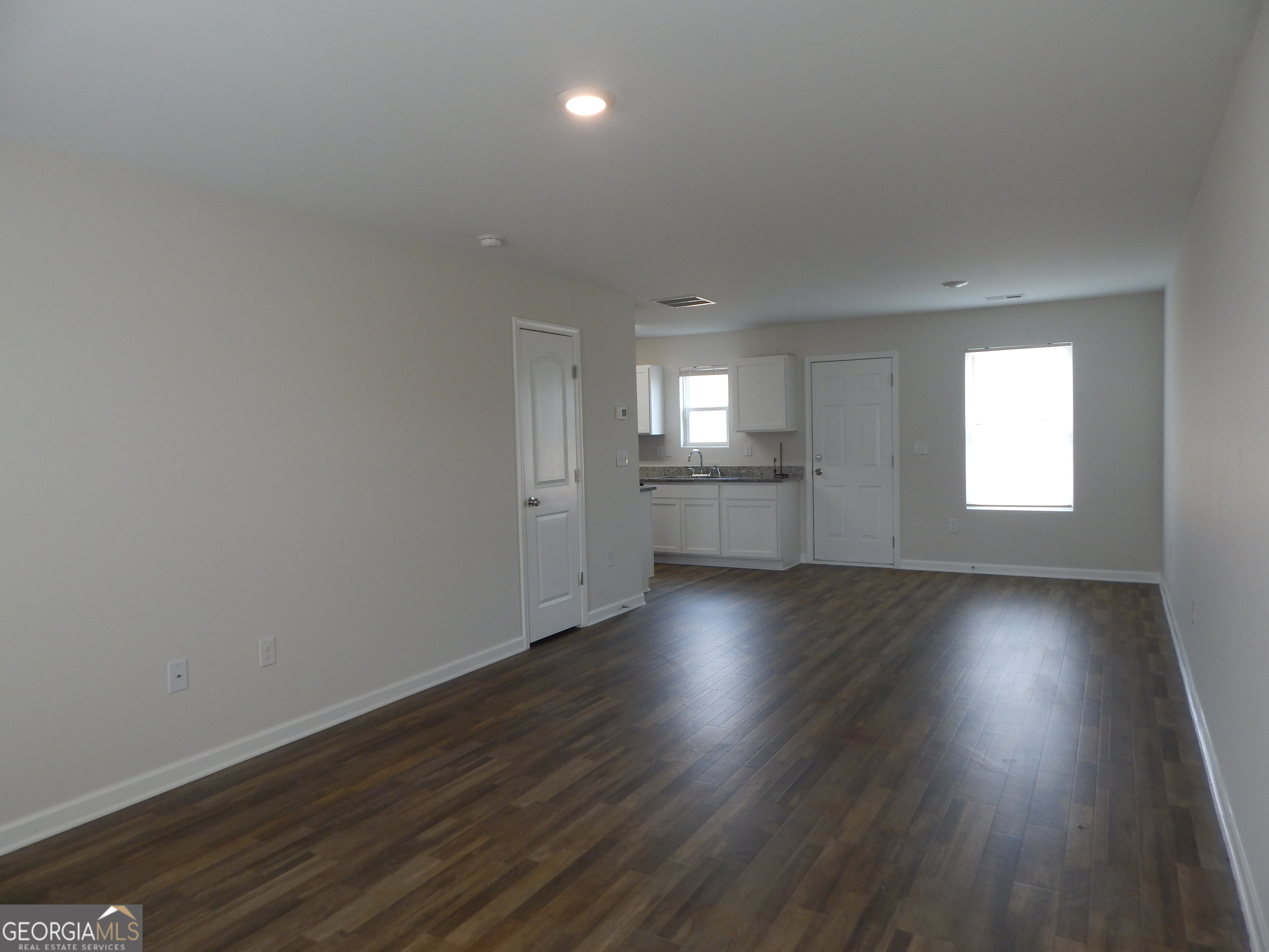 101 Sarah Lane LaGrange, GA 30241 - Photo 4 of 16 an empty room with wooden floor and windows