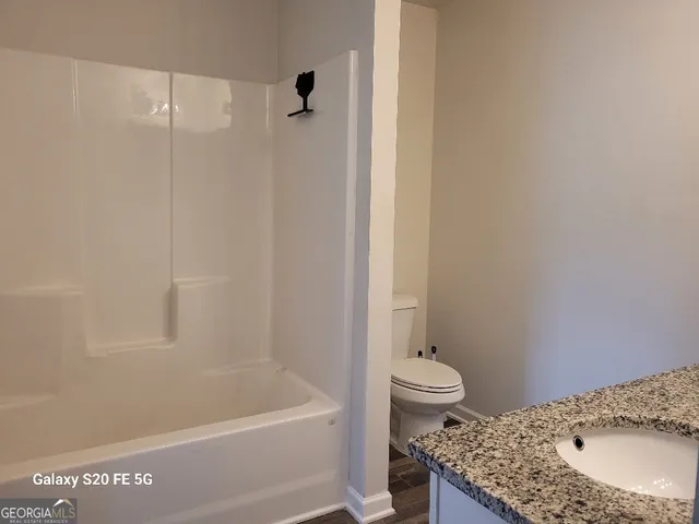 a bathroom with a sink a toilet and a bathtub