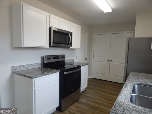 a kitchen with a sink and a stove top oven