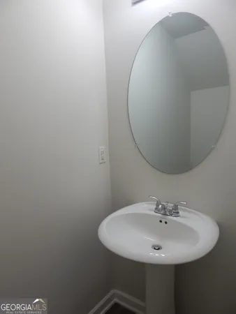 a bathroom with a sink and mirror