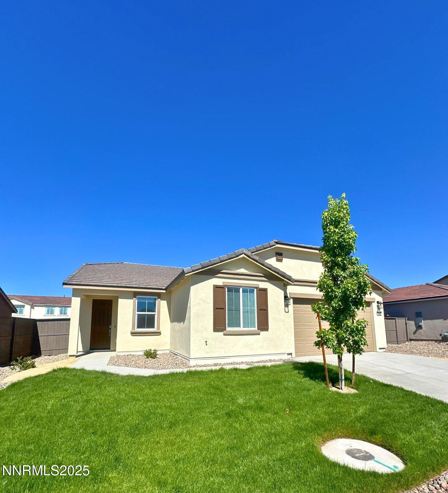 7145 Owl View Drive Sparks, NV 89436 - Photo 1 of 16 a front view of a house with a garden