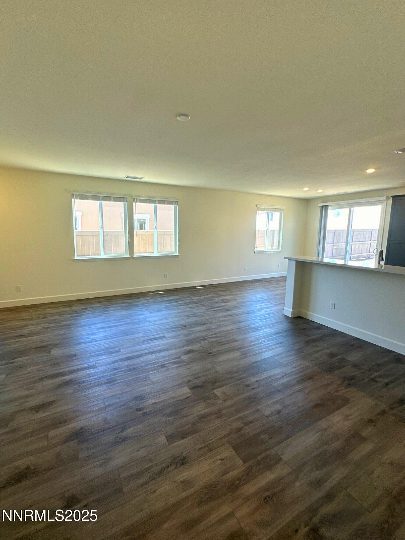 7145 Owl View Drive Sparks, NV 89436 - Photo 3 of 16 an empty room with wooden floor and windows