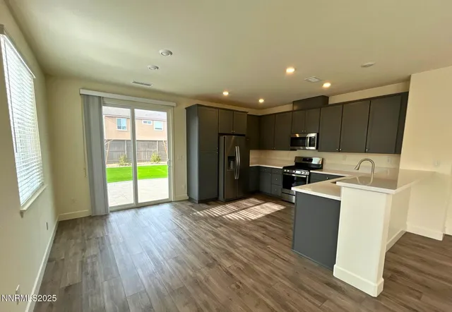 a kitchen with a refrigerator and a microwave