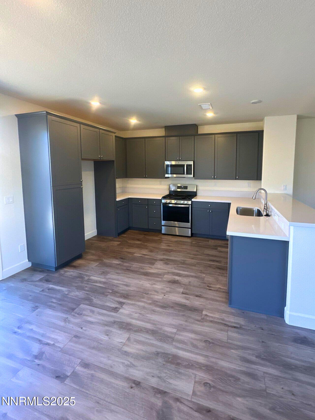 7145 Owl View Drive Sparks, NV 89436 - Photo 5 of 16 a kitchen with stainless steel appliances granite countertop a refrigerator and a stove