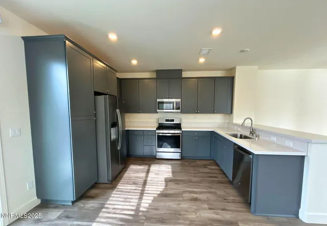 a open kitchen with stainless steel appliances granite countertop a refrigerator and a sink