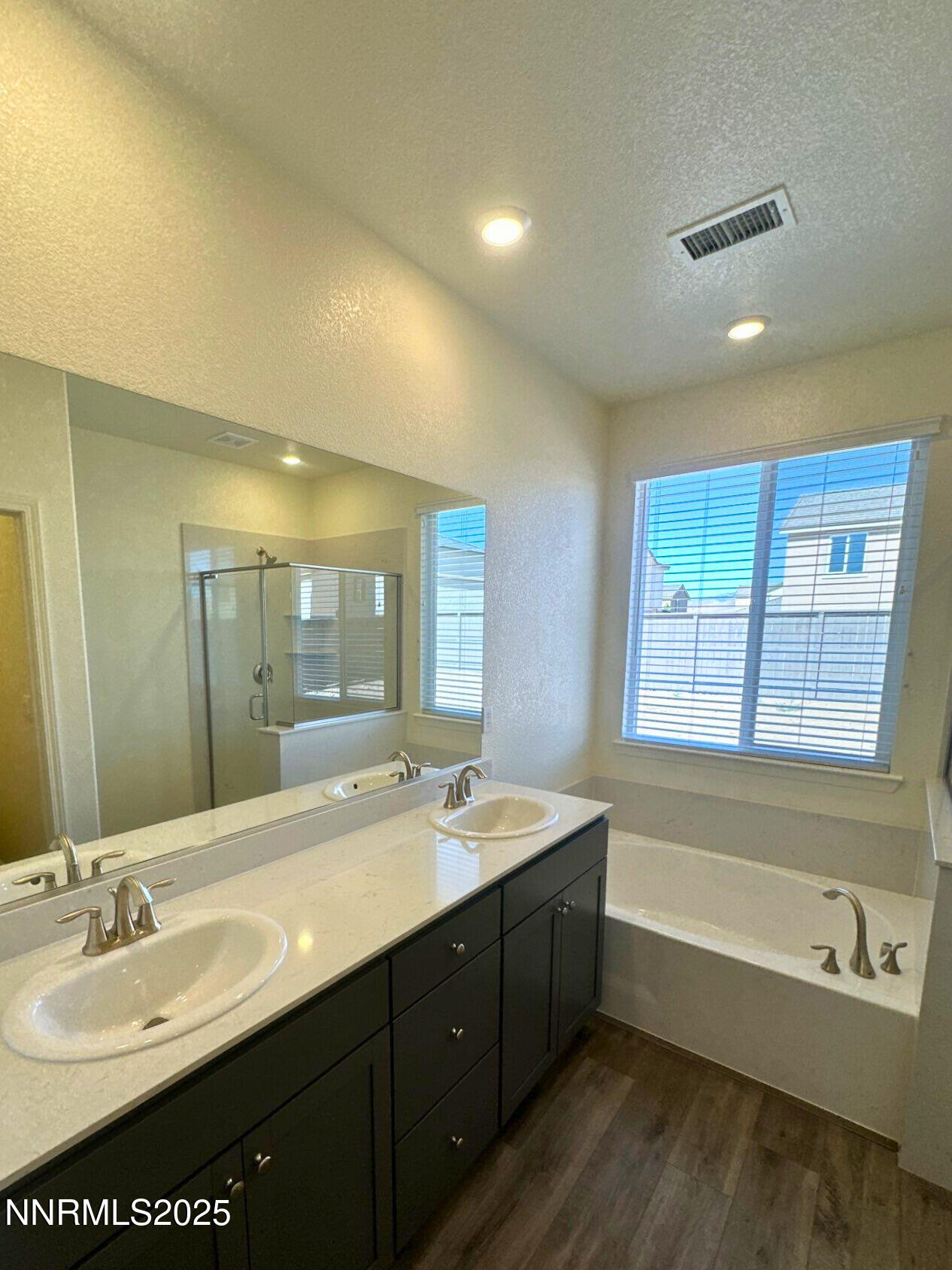 7145 Owl View Drive Sparks, NV 89436 - Photo 9 of 16 a bathroom with a tub sink double vanity granite and a tub