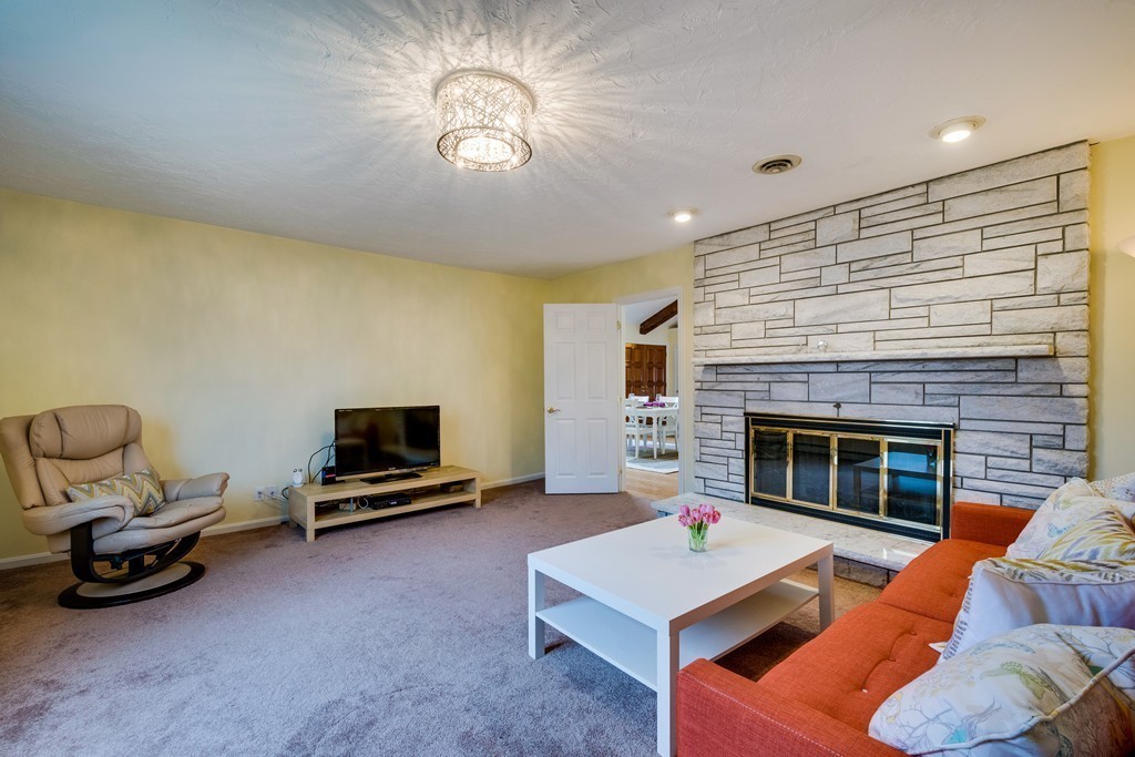 1 Winslow Road Needham, MA 02492 - Photo 18 of 27 a living room with furniture a flat screen tv and a fireplace