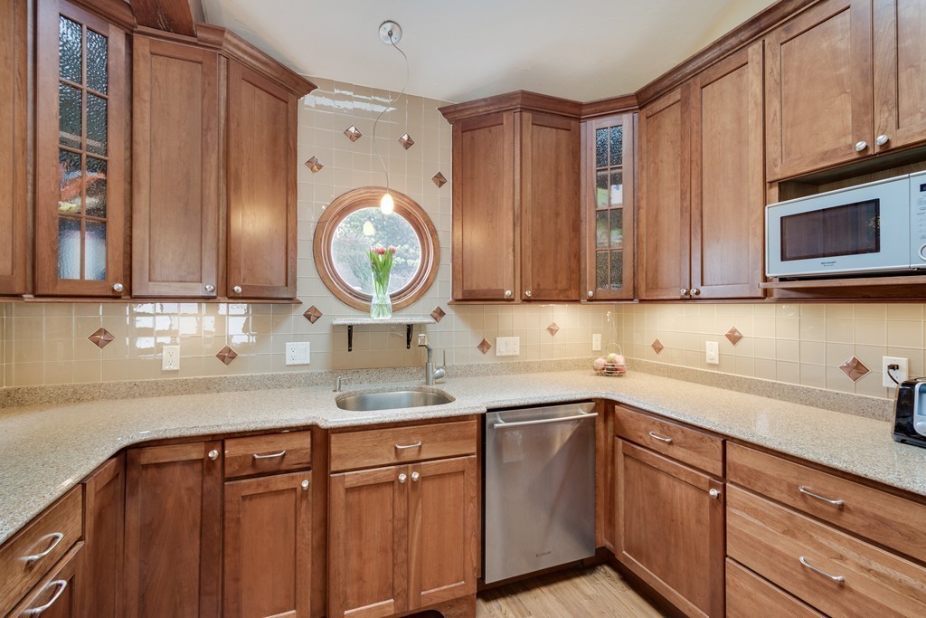 1 Winslow Road Needham, MA 02492 - Photo 7 of 27 a kitchen with stainless steel appliances granite countertop a sink a stove microwave and cabinets