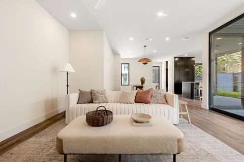 a large bedroom with a bed and wooden floor