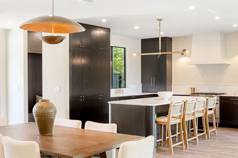 a kitchen with stainless steel appliances kitchen island granite countertop a dining table and chairs
