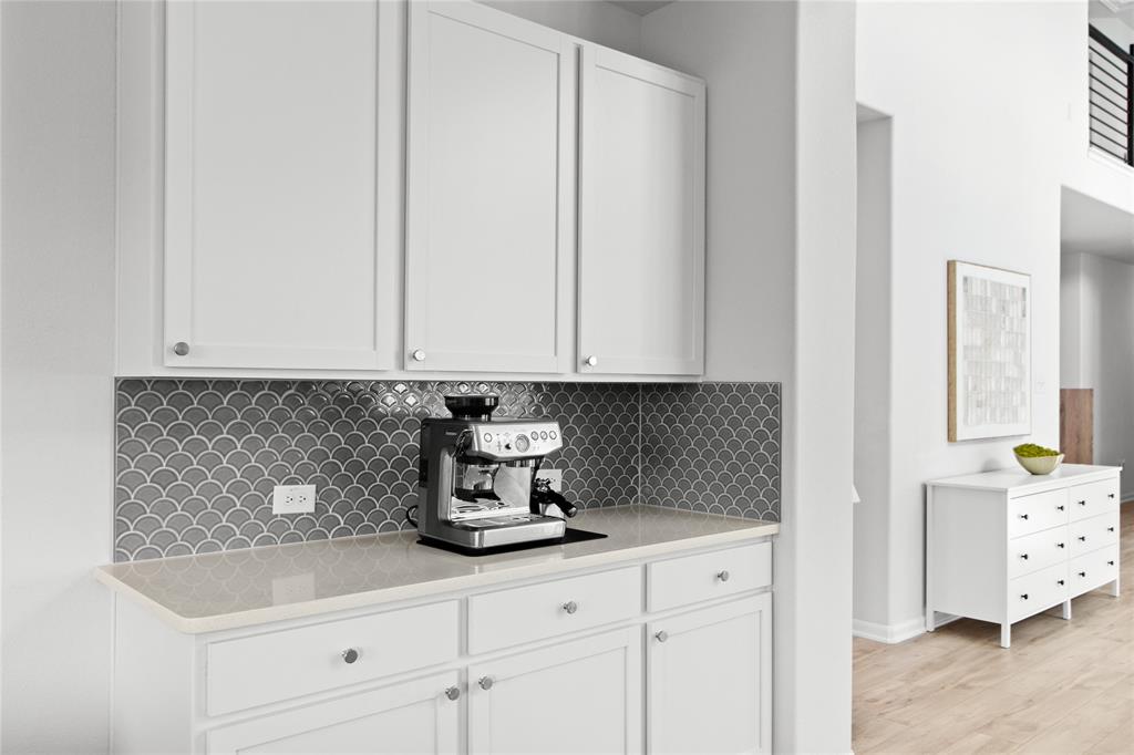 2070 Placerville Street Forney, TX 75126 - Photo 12 of 36 a kitchen with granite countertop white cabinets and sink