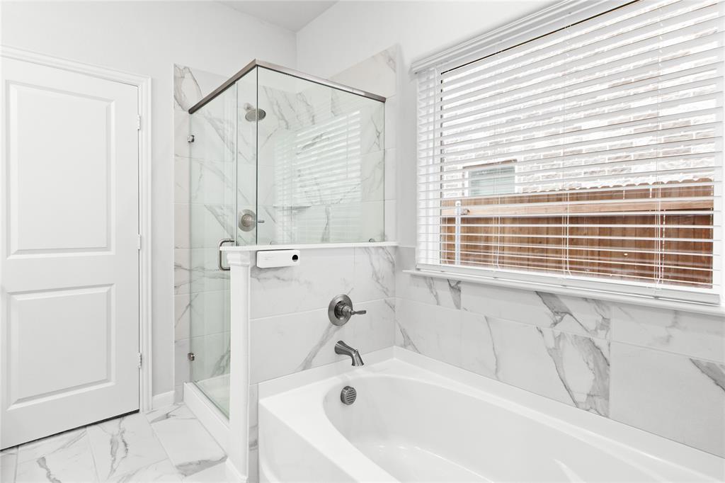 2070 Placerville Street Forney, TX 75126 - Photo 15 of 36 a bathroom with a bathtub and a shower