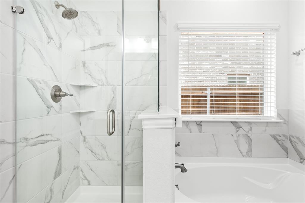 2070 Placerville Street Forney, TX 75126 - Photo 16 of 36 a bathroom with a bathtub and a shower