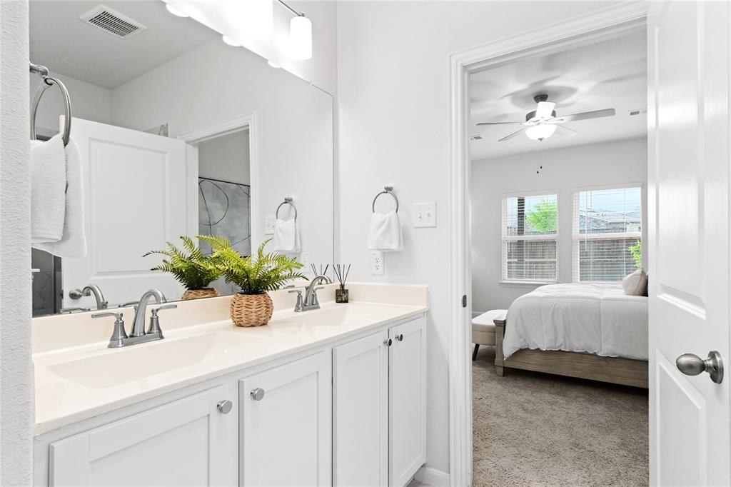 2070 Placerville Street Forney, TX 75126 - Photo 17 of 36 a en suite bathroom with a double vanity sink and a mirror