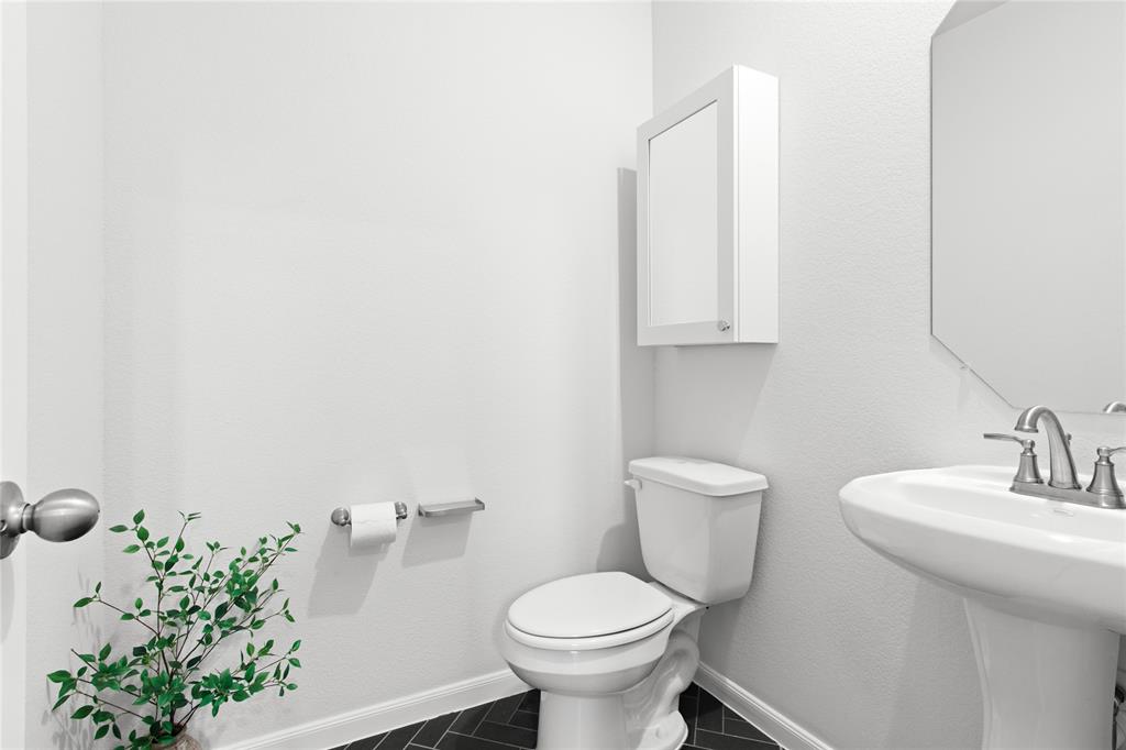 2070 Placerville Street Forney, TX 75126 - Photo 19 of 36 a bathroom with a toilet sink and mirror