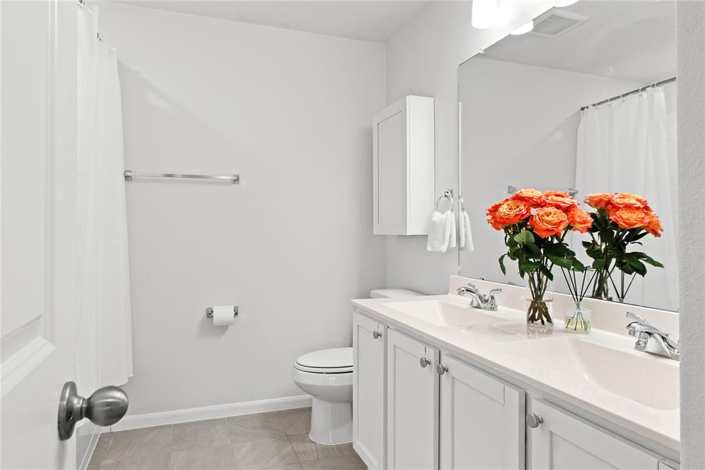 2070 Placerville Street Forney, TX 75126 - Photo 26 of 36 a bathroom with a sink a vanity and a mirror