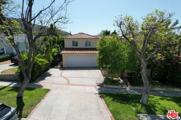 an aerial view of a house with a yard and garden
