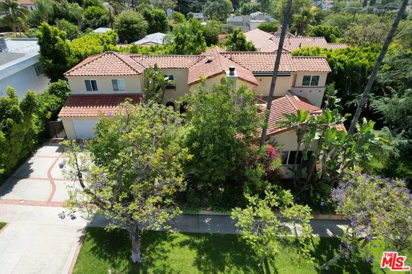 an aerial view of a house with a yard patio and lake view