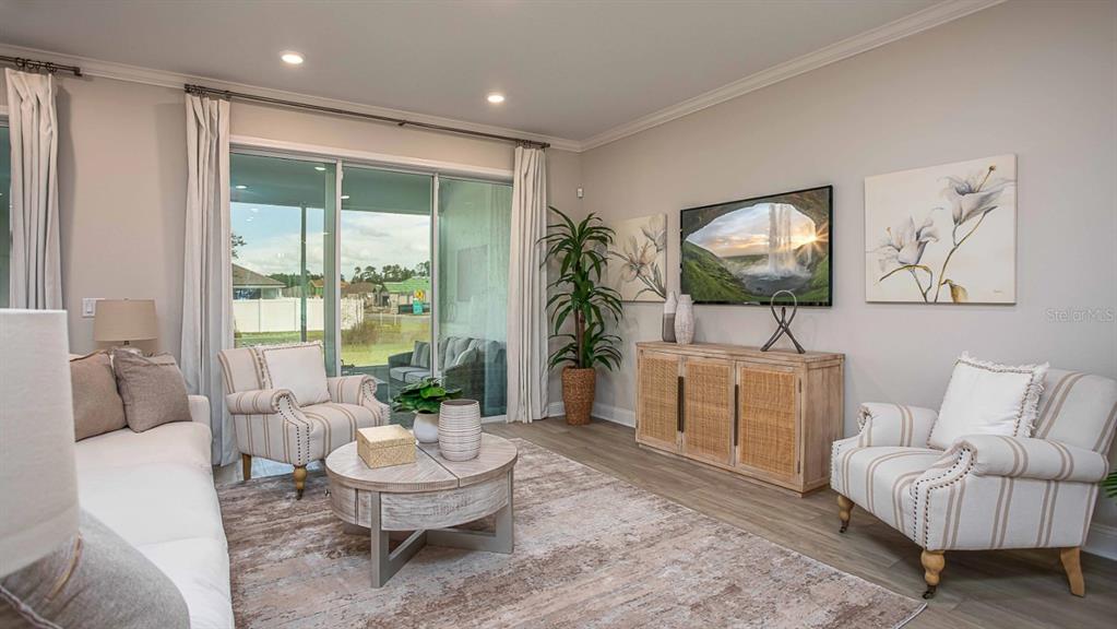 1103 Nackman Road North Port, FL 34288 - Photo 9 of 26 a living room with furniture and a flat screen tv