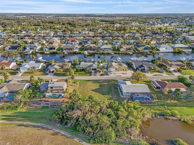 an aerial view of residential houses with outdoor space and swimming pool