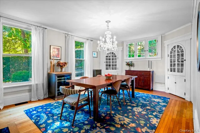 a dining room with furniture a rug and wooden floor