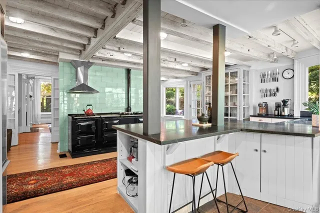 a living room with table chairs and a large window