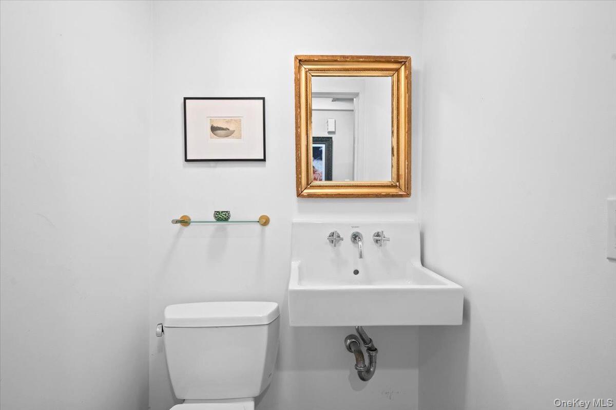 245 River Road Nyack, NY 10960 - Photo 23 of 45 a bathroom with a toilet sink and mirror