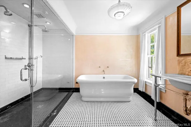 a spacious bathroom with a bathtub and a sink