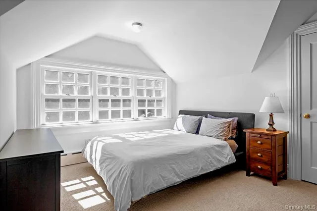 a spacious bathroom with a tub sink and mirror