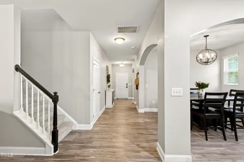 a view of a hallway with wooden floor windows and entryway