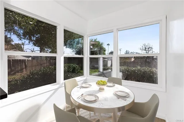 a view of a dining room with furniture wooden floor and a floor to ceiling window