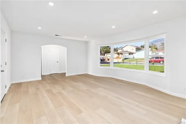 a view of a livingroom with wooden floor and window