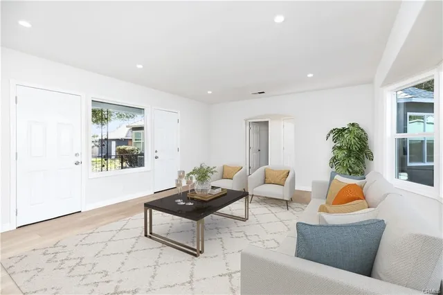 a living room with furniture and a potted plant