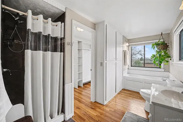 a view of a bedroom with a bed and wooden floor