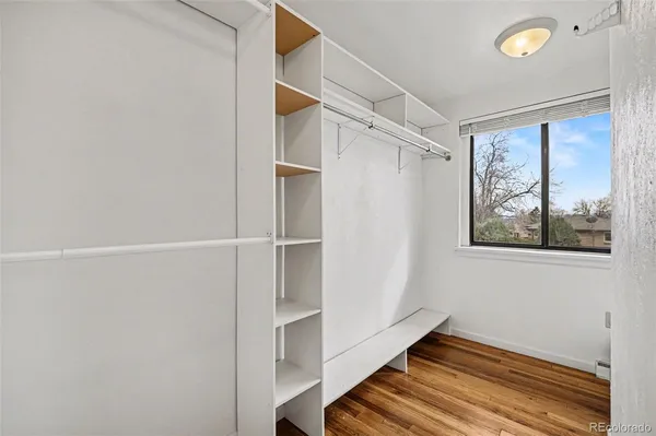 a bedroom with a bed and a tv on dresser
