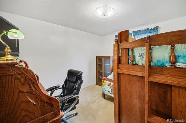 a living room with furniture a flat screen tv and a table